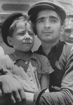 Yisrael Meir Lau (8 years old) in the arms of Elazar Schiff, Buchenwald survivors at their arrival at Haifa on 15 July 1945