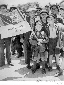 Rabbi Lau as a boy, holding the flag